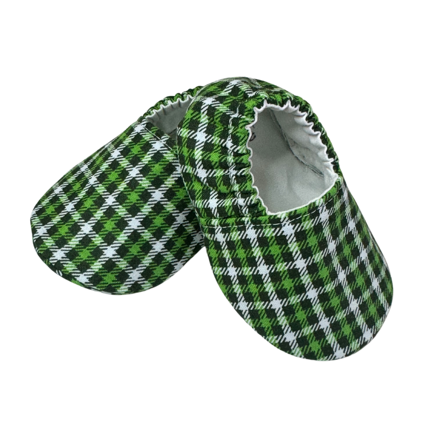 “Side view of handmade green plaid soft sole baby moccasins, 3-6 months”