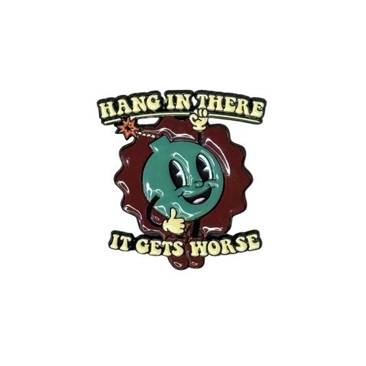 “Bomb cartoon enamel pin with phrase ‘Hang In There… It Gets Worse’”