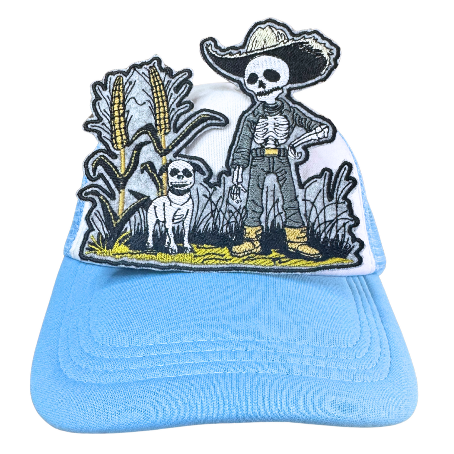 The Harvest Guardian embroidered patch applied to a light blue trucker hat.