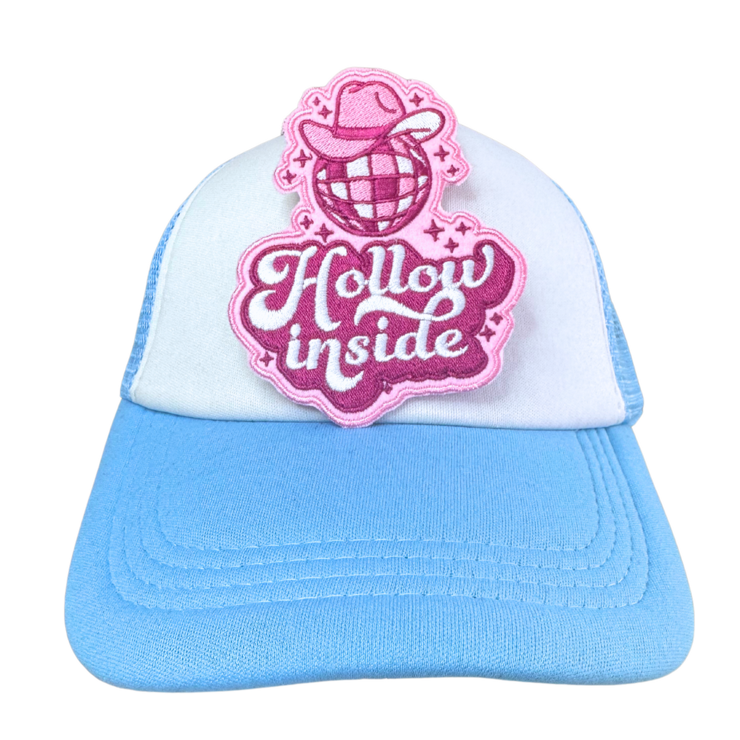 Hollow Inside embroidered patch applied to a light blue trucker hat.