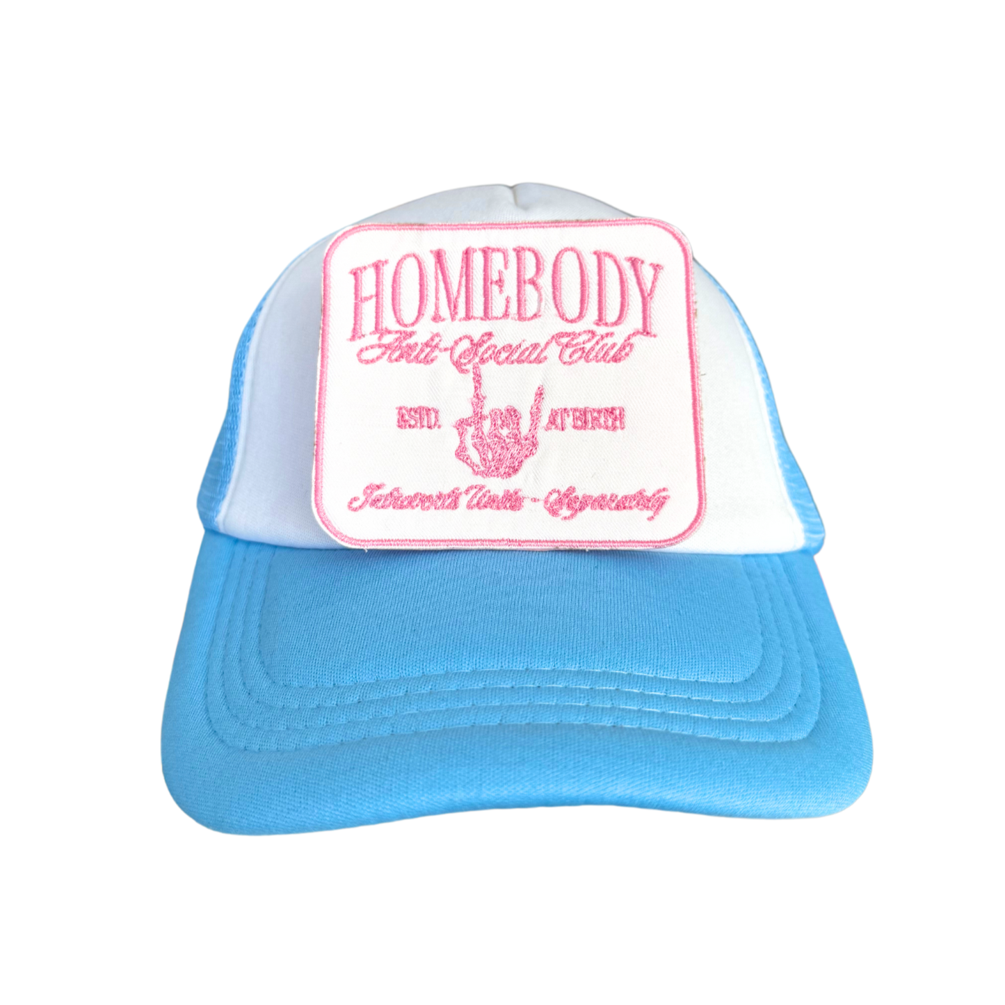 White trucker hat with iron-on Homebody Anti-Social Club patch attached.