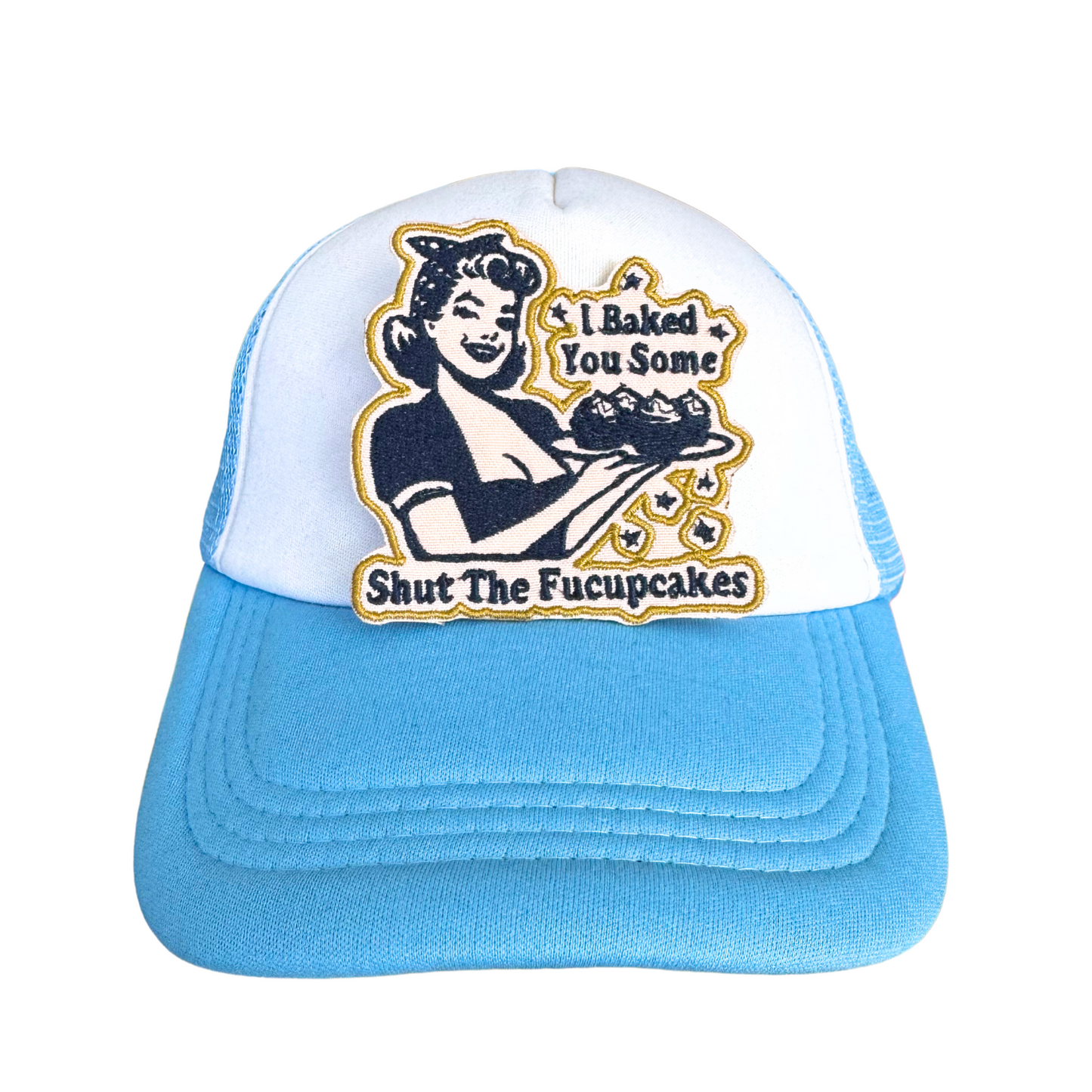 White and blue trucker hat with "I Baked You Some Shut the Fucupcakes" embroidered patch attached to the front.