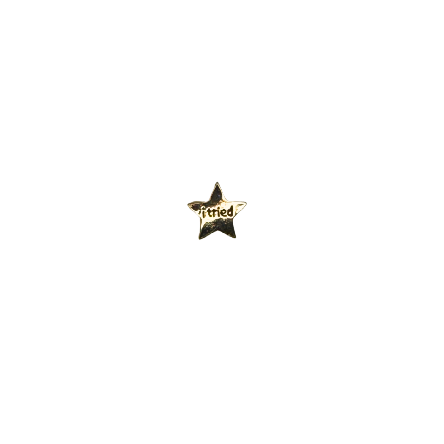 Hero shot of a gold star enamel pin that says “i tried”