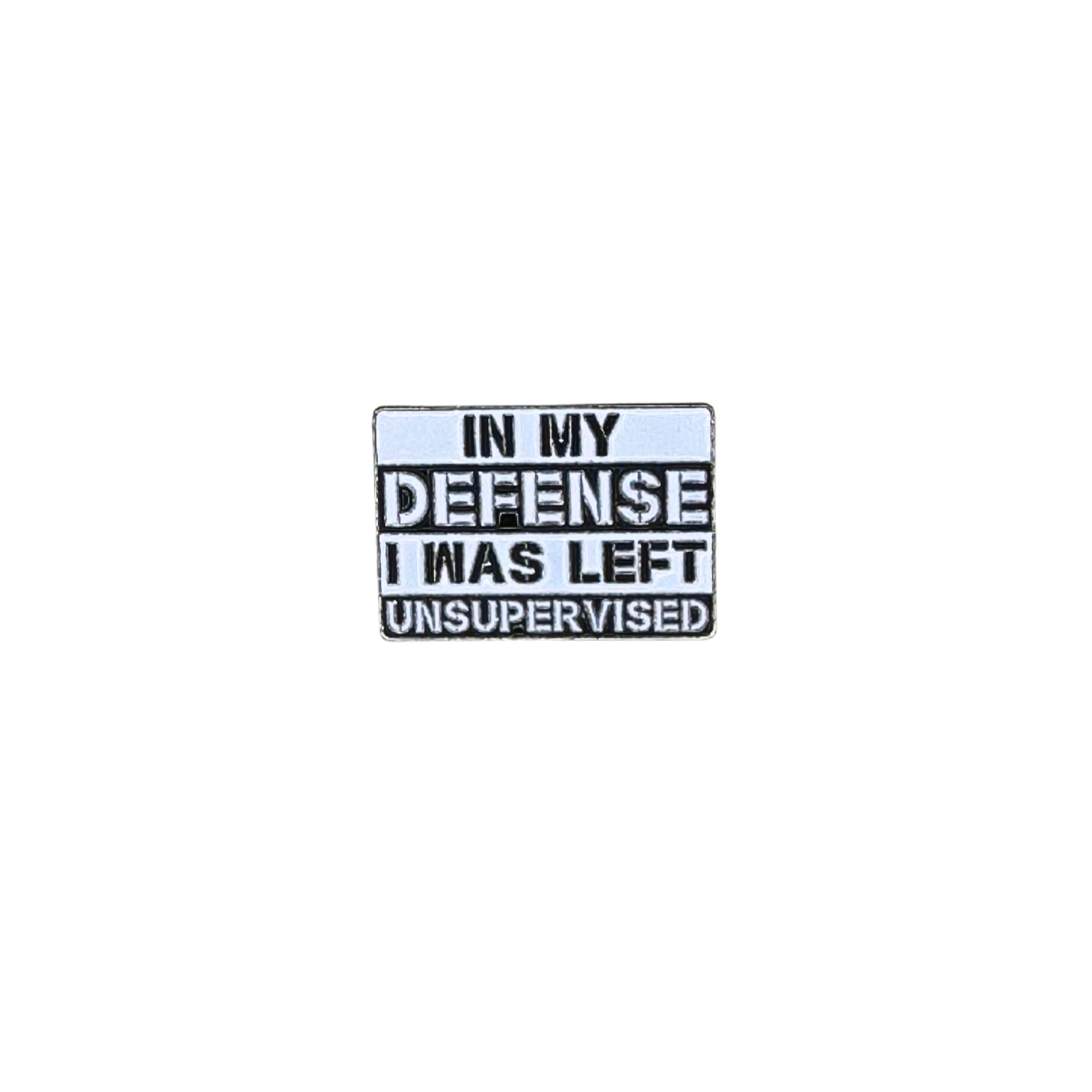 Hero image of a white enamel pin that says “In my defense I was left unsupervised”