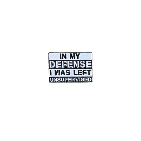 Hero image of a white enamel pin that says “In my defense I was left unsupervised”