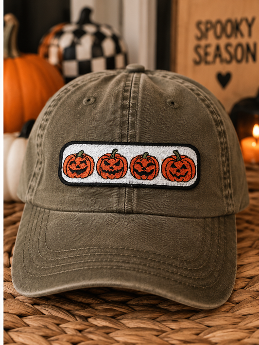 Jack-O'-Lantern Parade embroidered Halloween patch styled on an olive dad hat