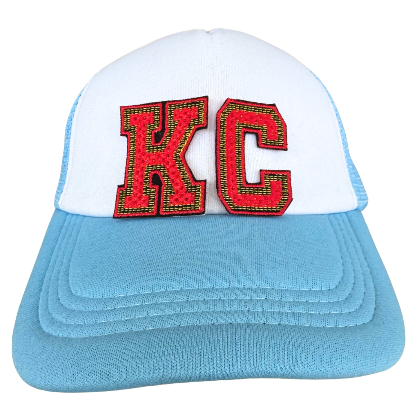 White and blue trucker hat featuring red and gold KC varsity patch inspired by the Kansas City Chiefs