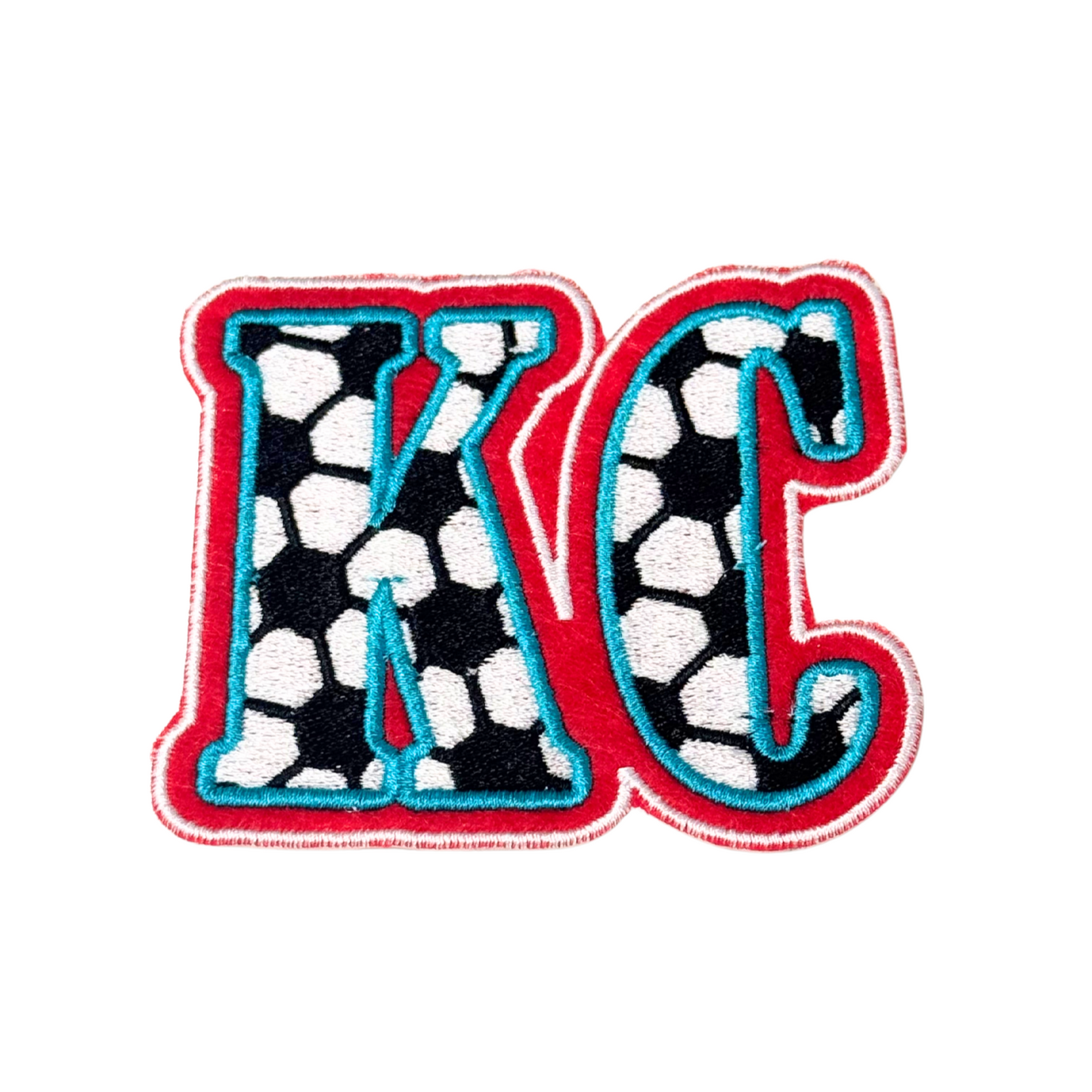 Embroidered KC patch with soccer ball pattern in red and aqua KC Current colors