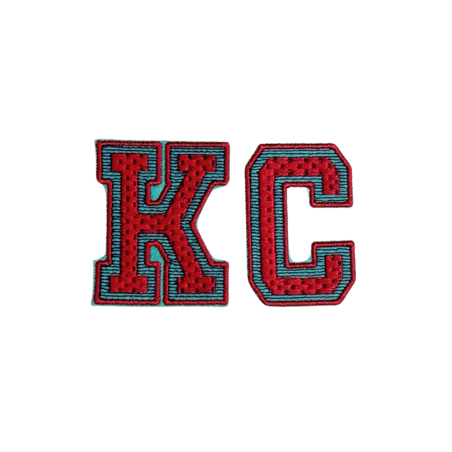 KC varsity-style patch in red chenille with teal and black outline