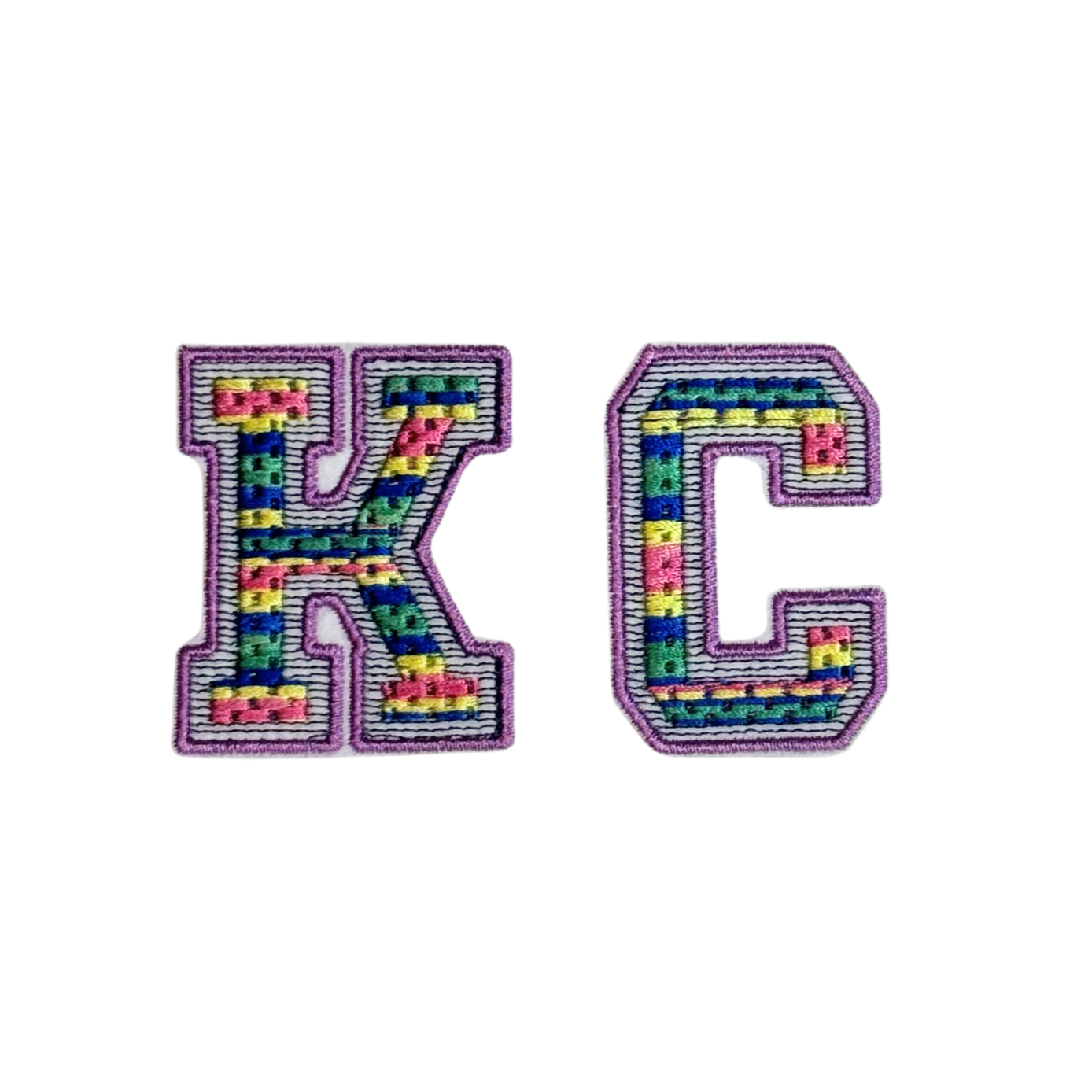 Multicolor varsity-style KC patch with rainbow thread and lilac border