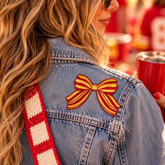 KC red and gold striped bow iron-on patch styled on denim jacket