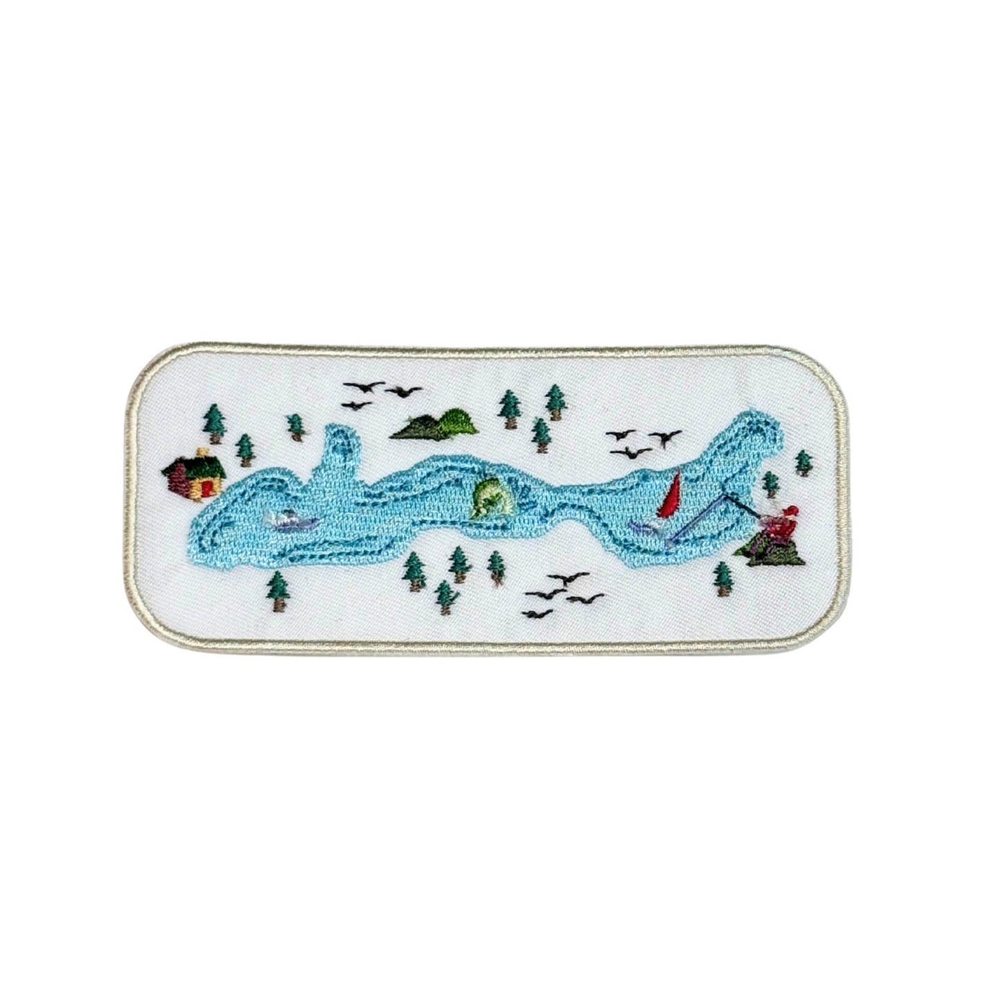 Embroidered patch with a scenic map featuring a lake, trees, cabin, tent, and birds in flight