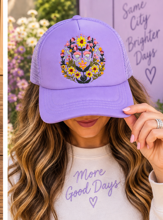 Model wearing lavender hand-embroidered floral hat