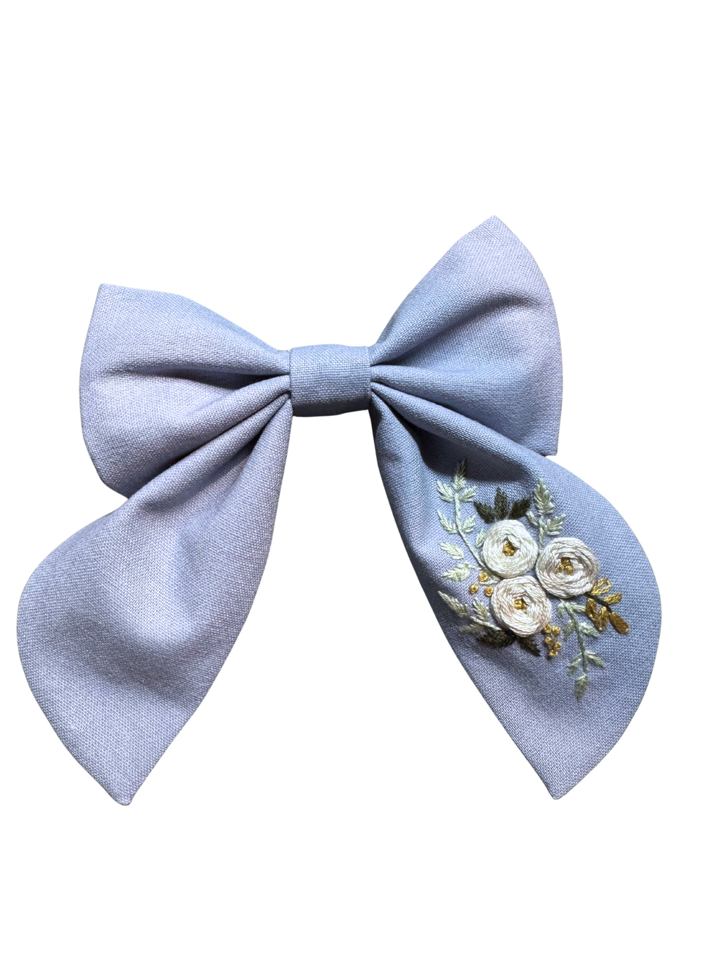 Light blue bow with floral embroidery on a white background