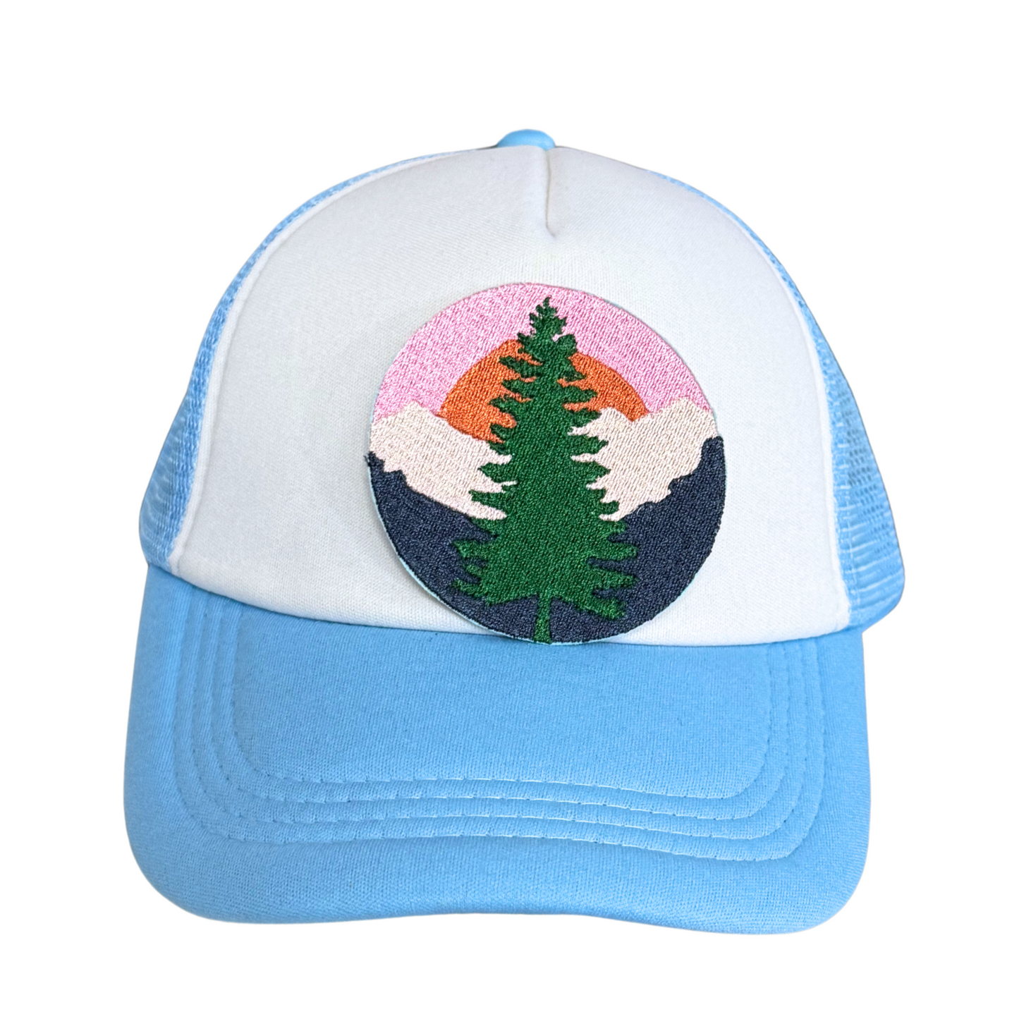 Light blue and white trucker hat with an embroidered mountain sunset pine tree patch attached.