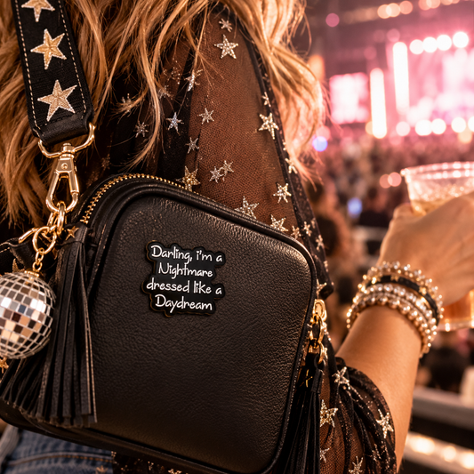 Nightmare Dressed Like a Daydream enamel pin on black concert bag lifestyle image