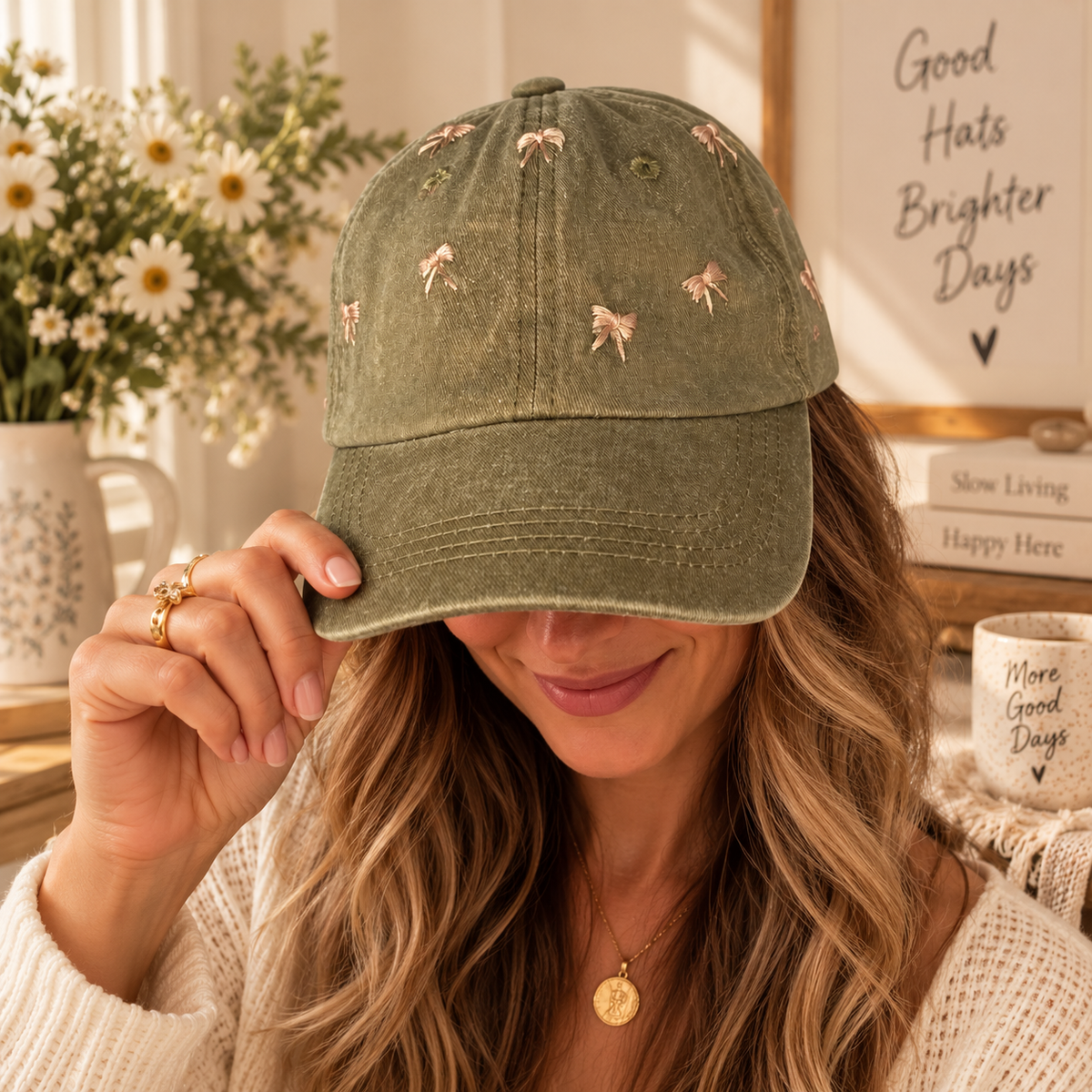Woman wearing olive hat with hand-embroidered blush bows