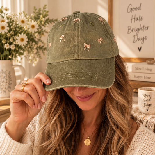 Woman wearing olive hat with hand-embroidered blush bows