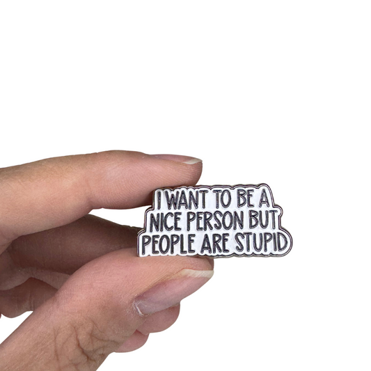 Enamel pin held in hand showing size and detail