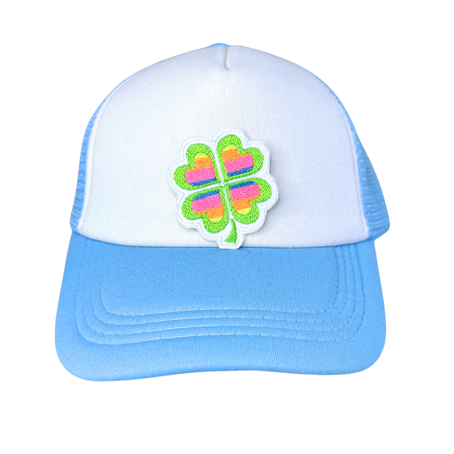 "Blue and white trucker hat featuring an embroidered rainbow heart four-leaf clover patch."