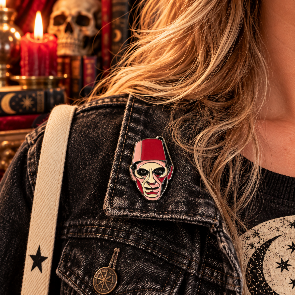 Red fez horror ghoul enamel pin worn on a charcoal denim jacket