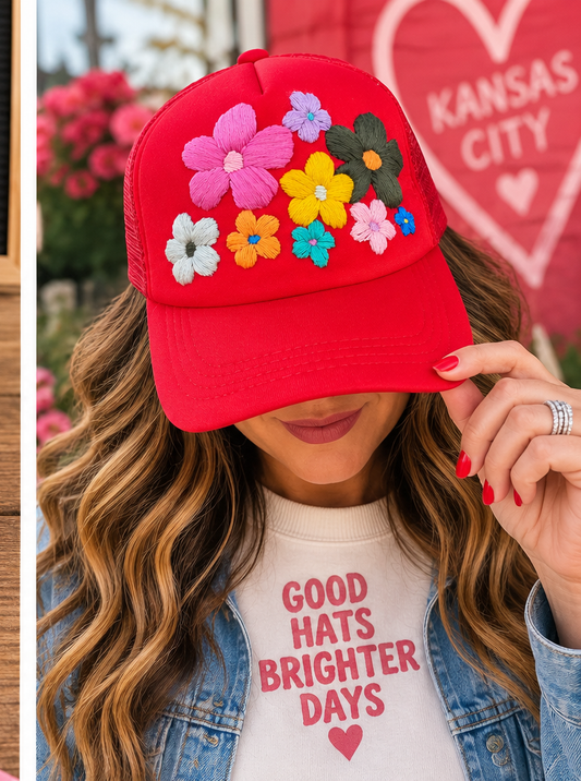 Model wearing red hand-embroidered floral hat