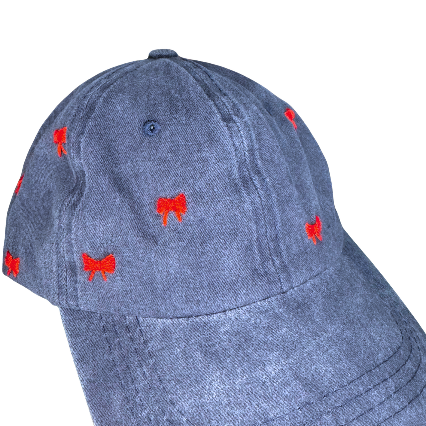 Blue cap with red embroidered designs on a white background