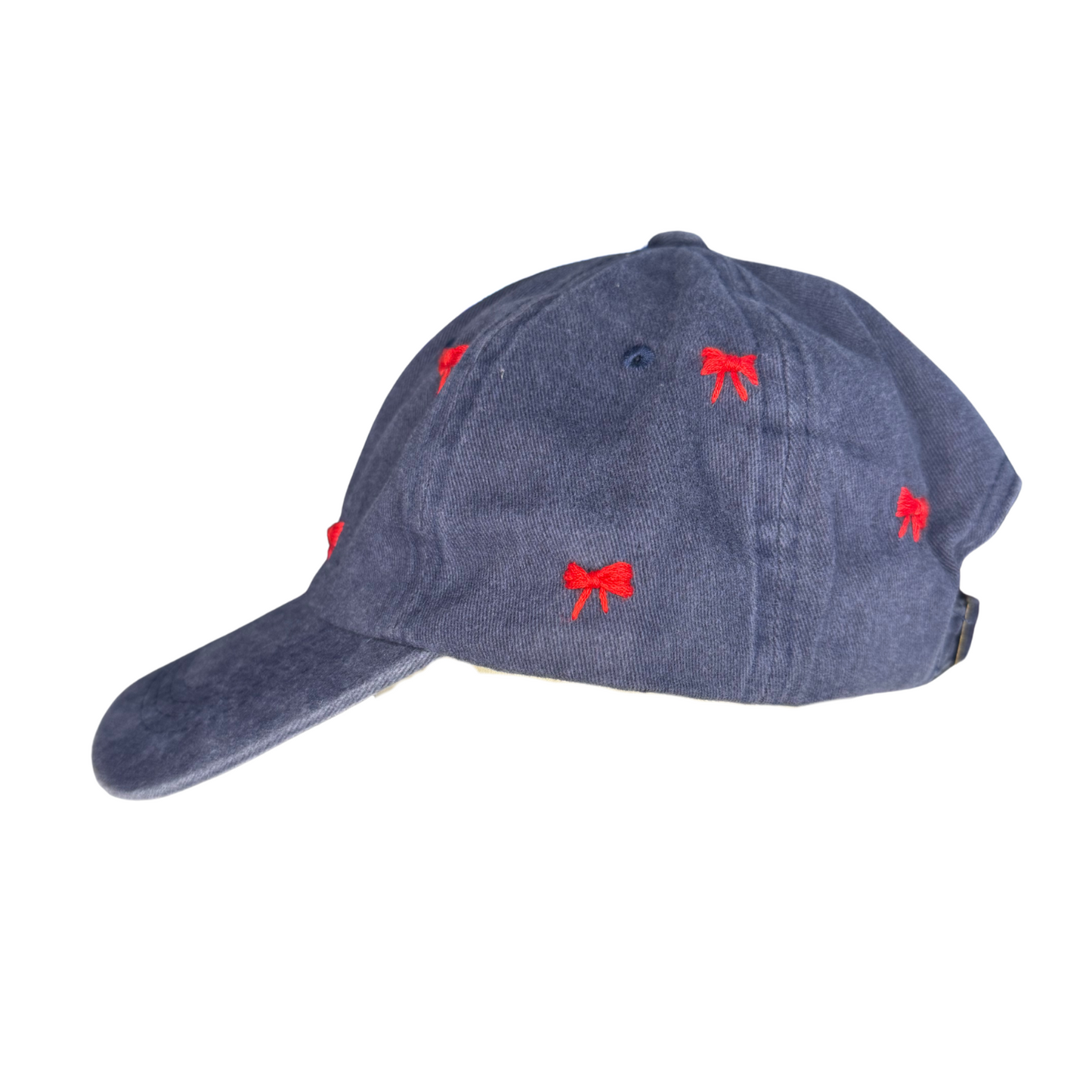 Blue denim cap with red bow patterns on a white background