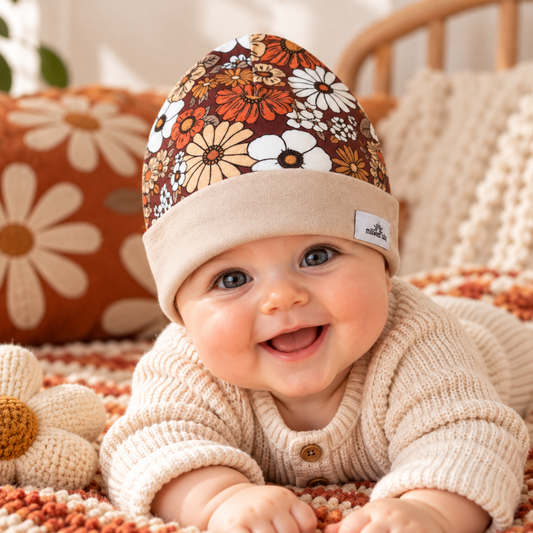 Baby wearing retro floral organic cotton beanie with beige cuff
