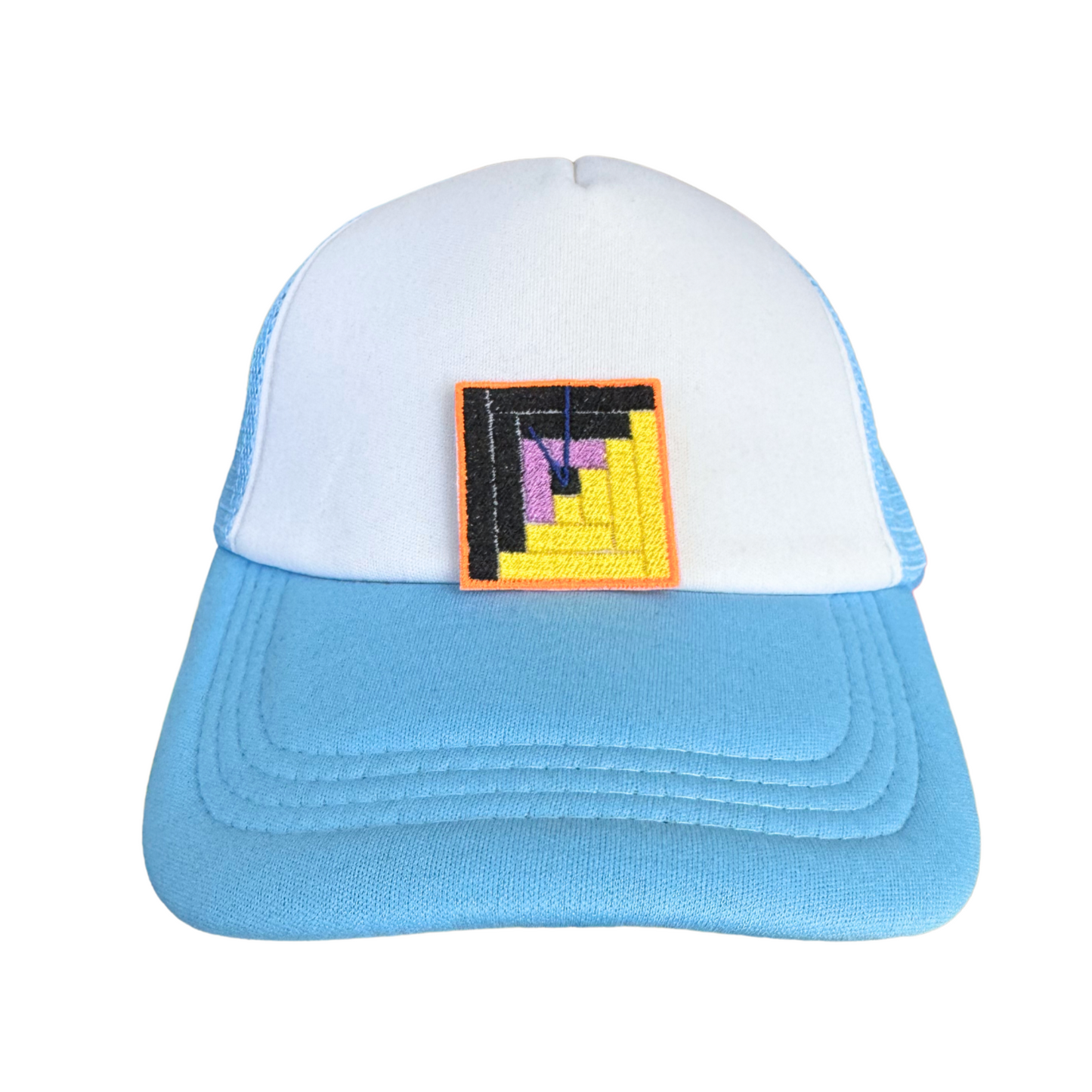 Blue and white trucker hat featuring the Safehouse embroidered patch, symbolizing resilience and community aid.