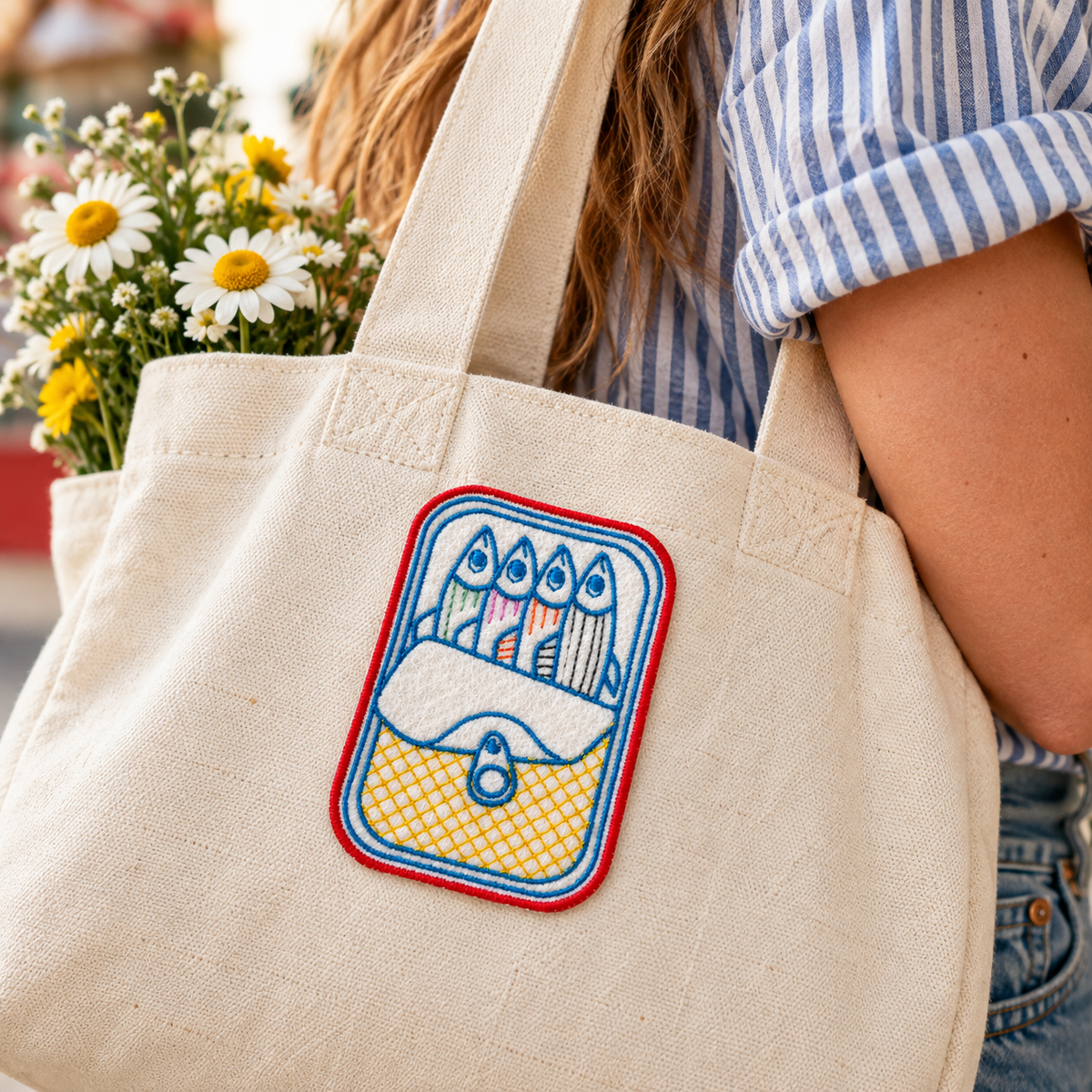 Sardine tin embroidered patch styled on a cream canvas tote