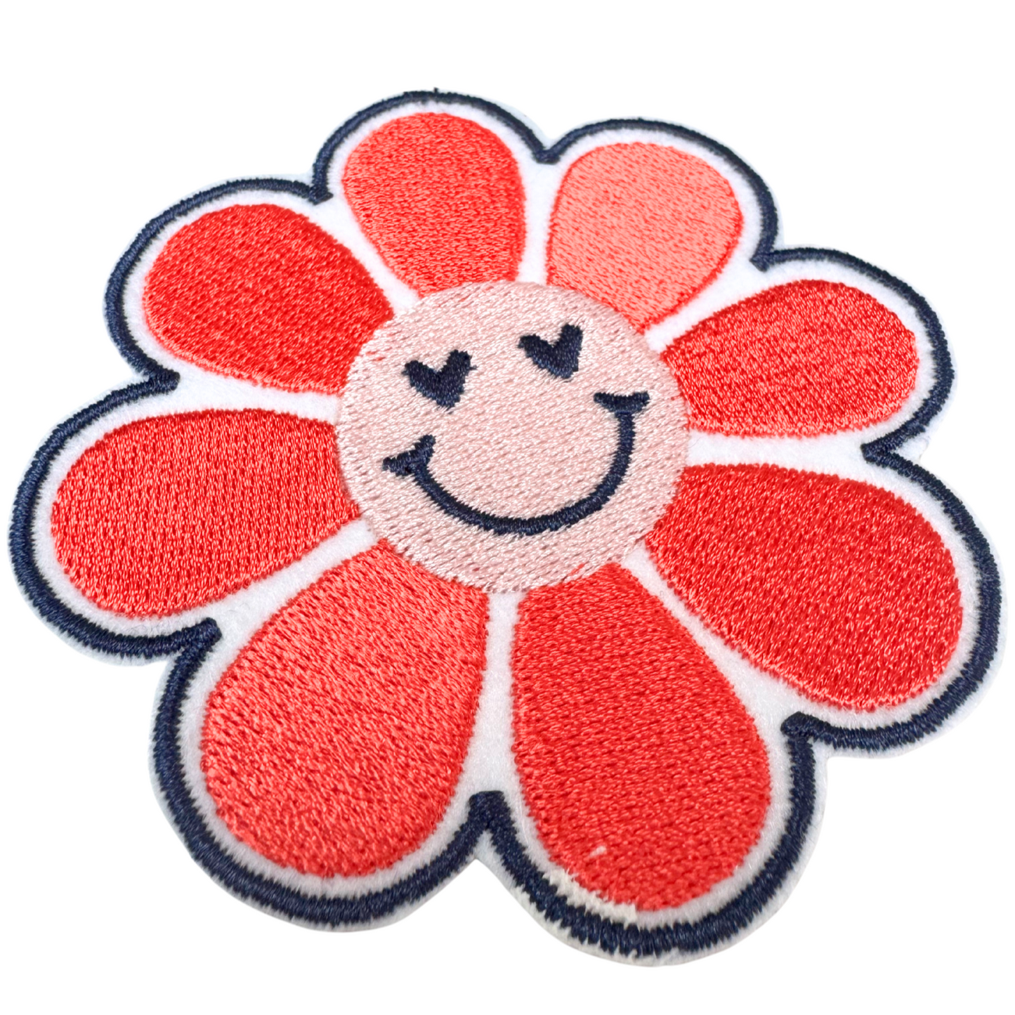 Close-up angled view of embroidered smiley flower iron-on patch