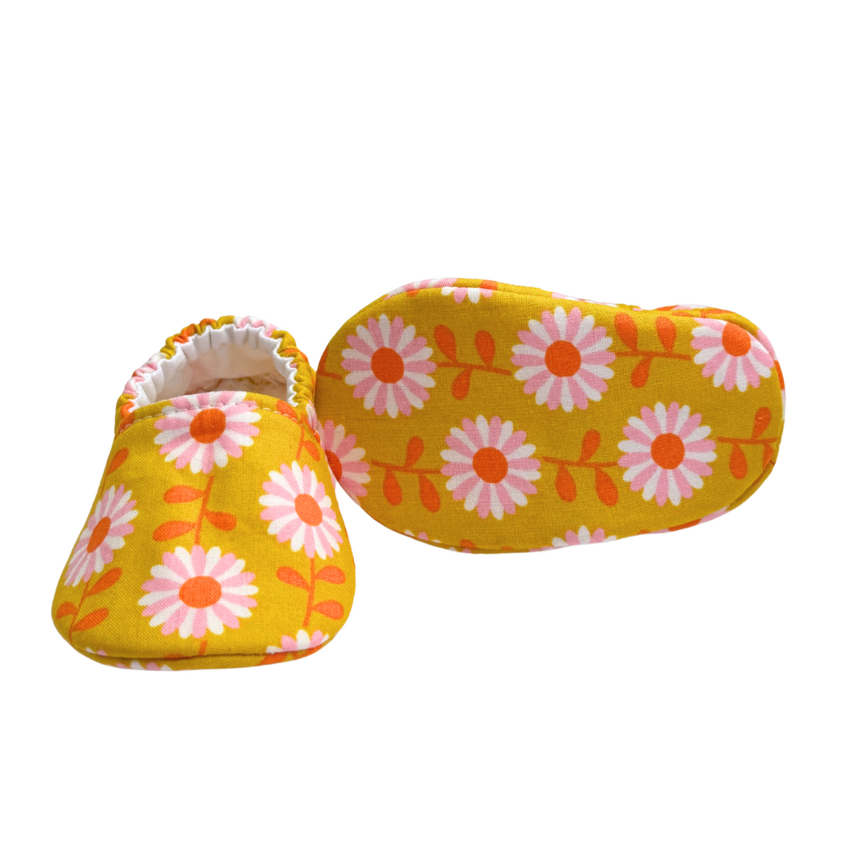 Bottom view of daisy baby moccasins, highlighting the soft, flexible soles designed for early foot development and all-day comfort.
