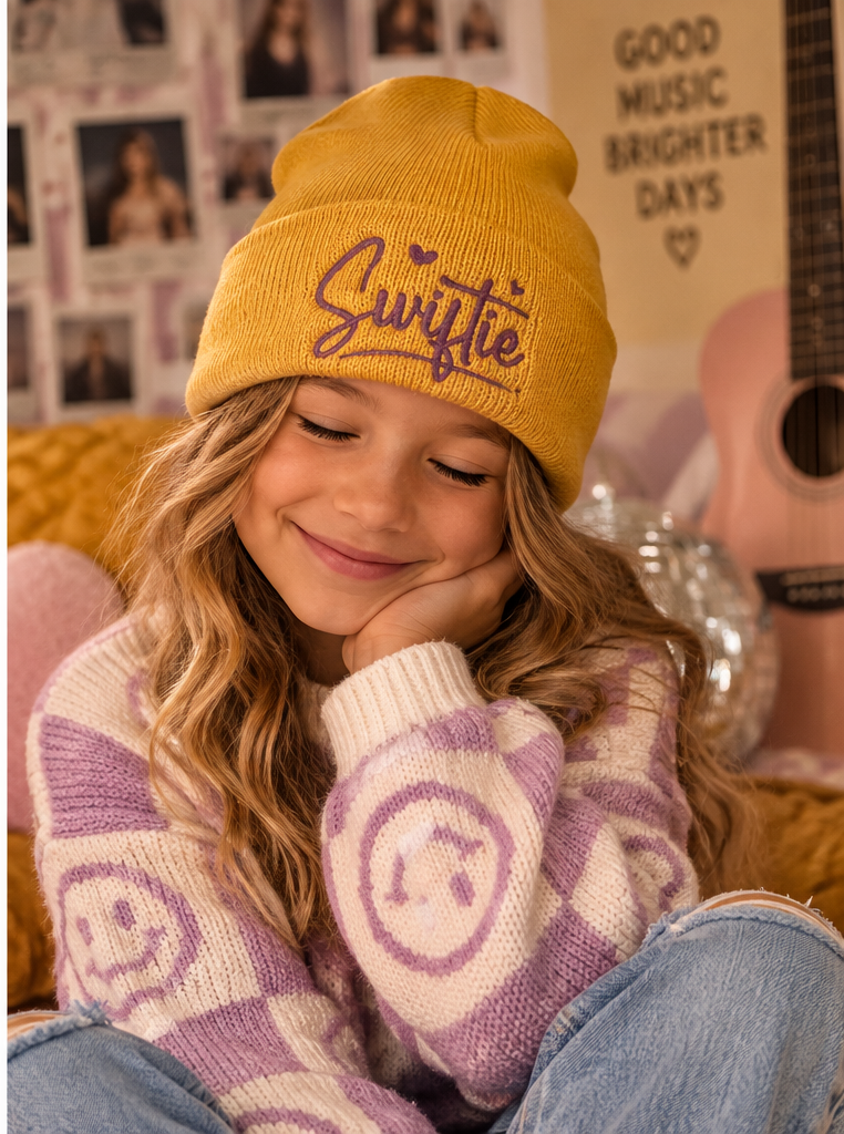 Youth model wearing mustard yellow Swiftie embroidered beanie