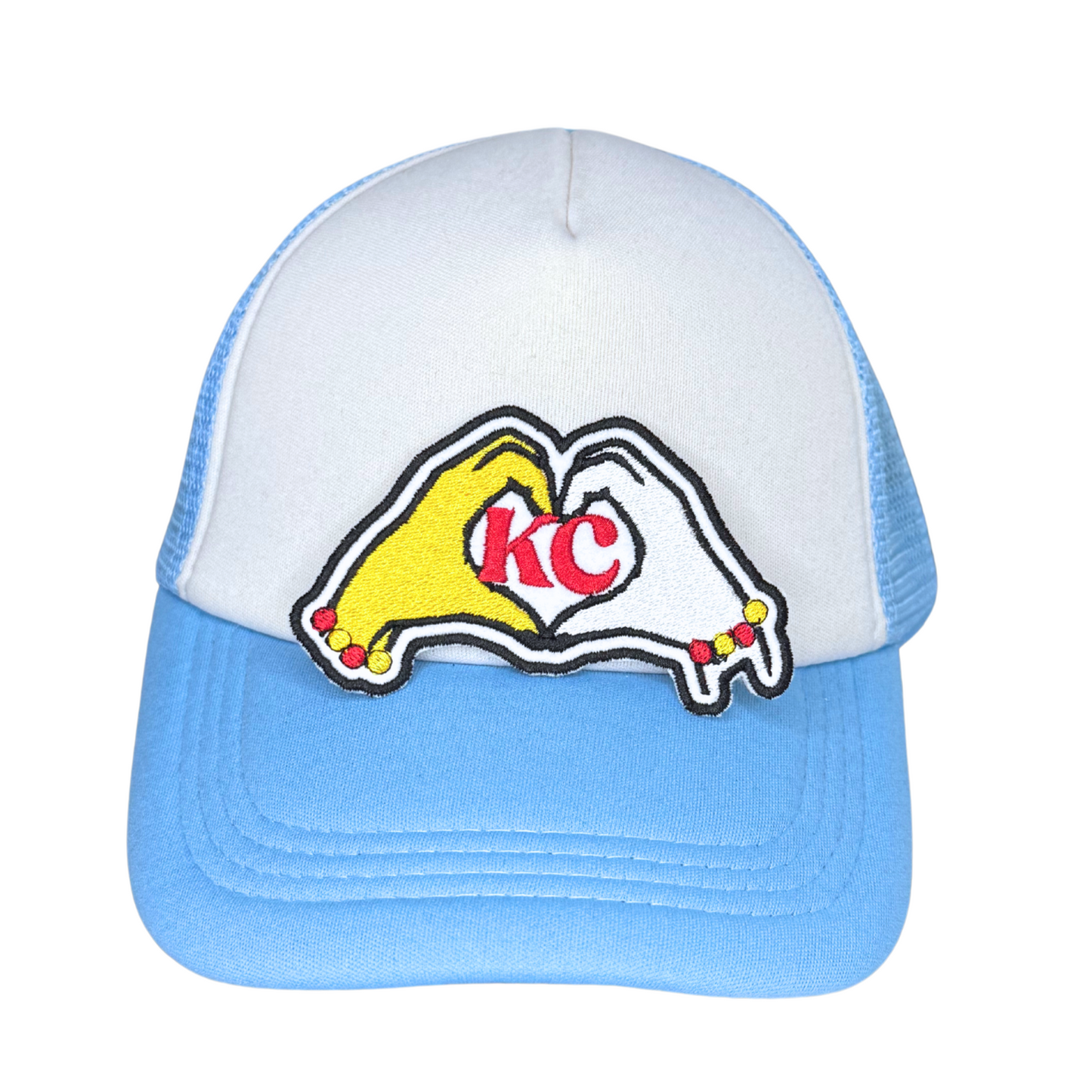 KC heart hands patch pressed onto a white and blue trucker hat