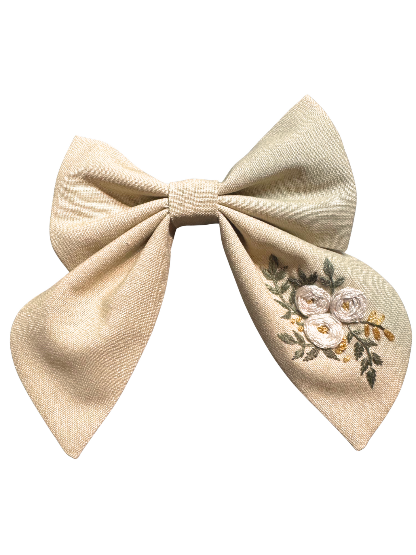 Beige bow with floral embroidery on a white background