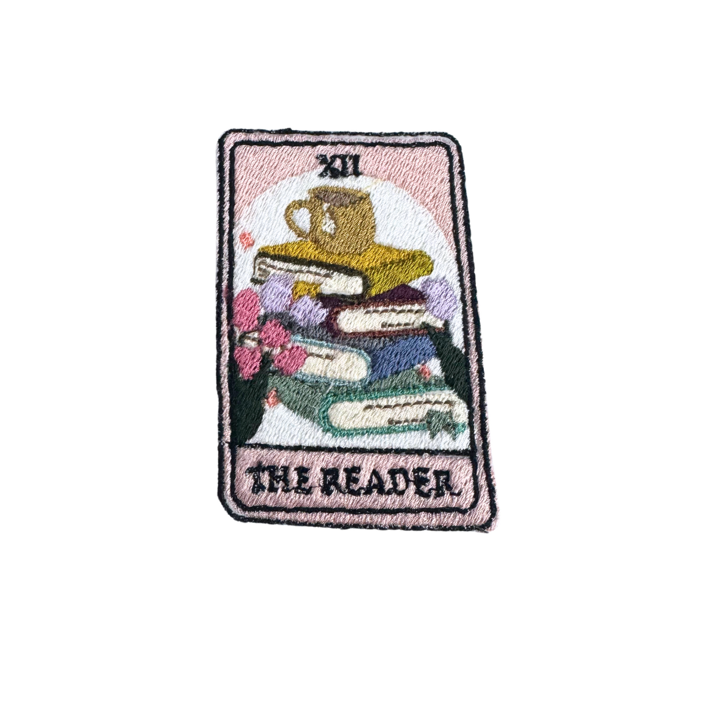 Handmade "The Reader" tarot-inspired embroidered patch featuring books, a teacup, and floral details.