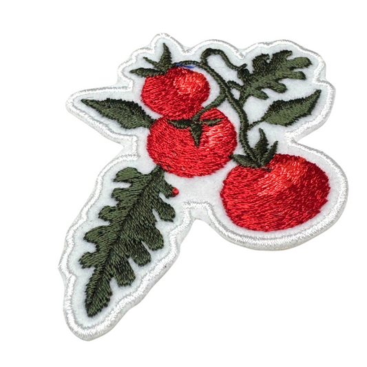 Close-up showing stitching detail of tomato vine embroidery