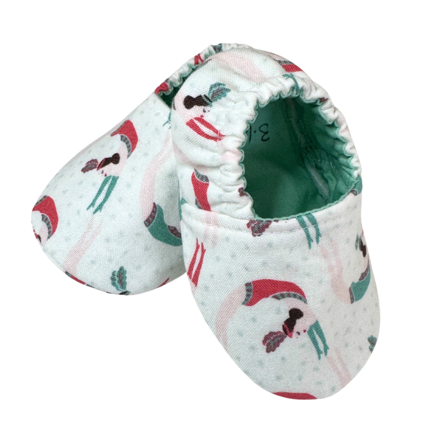 “Side view of handmade baby moccasins with circus trapeze artist women print, soft sole, 3-6 months”