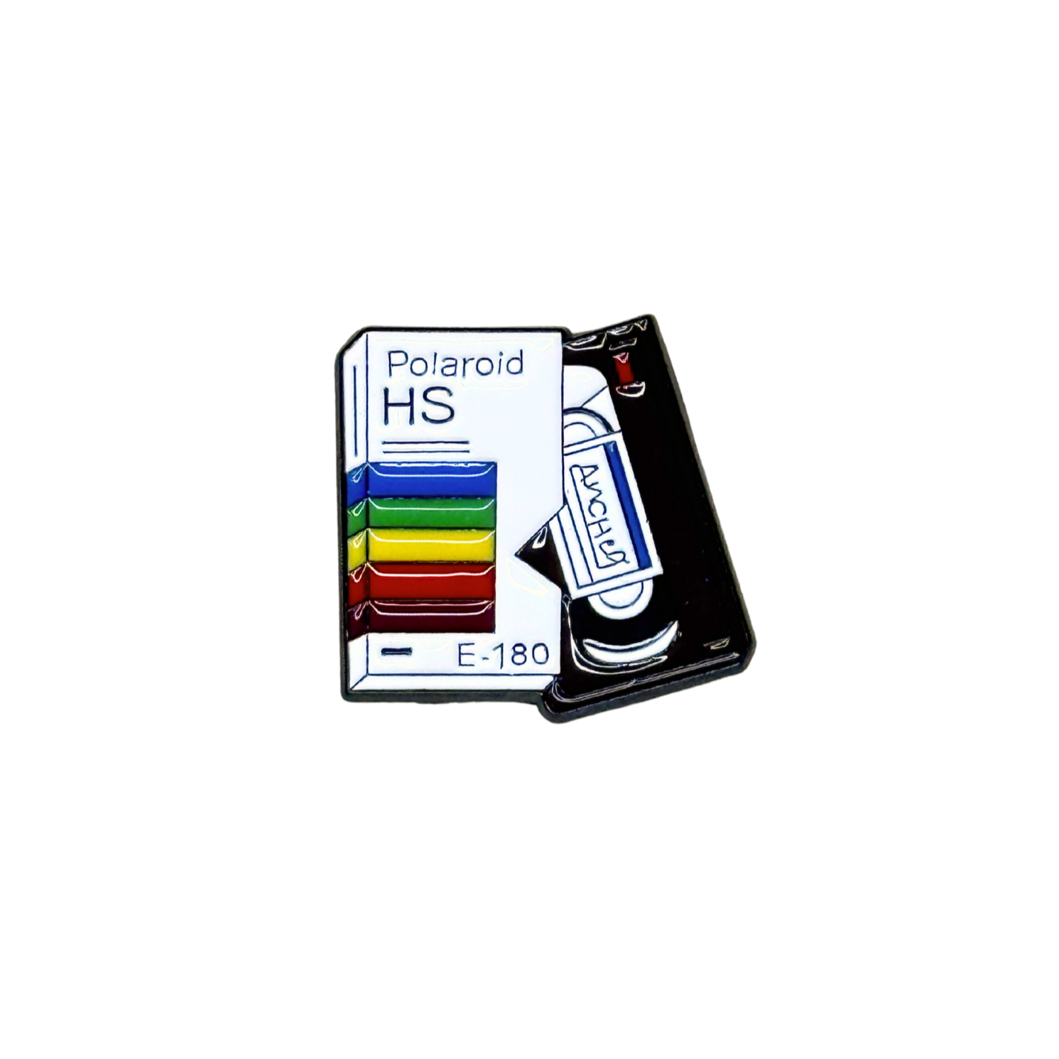 Close-up of retro VHS enamel pin featuring rainbow-striped sleeve