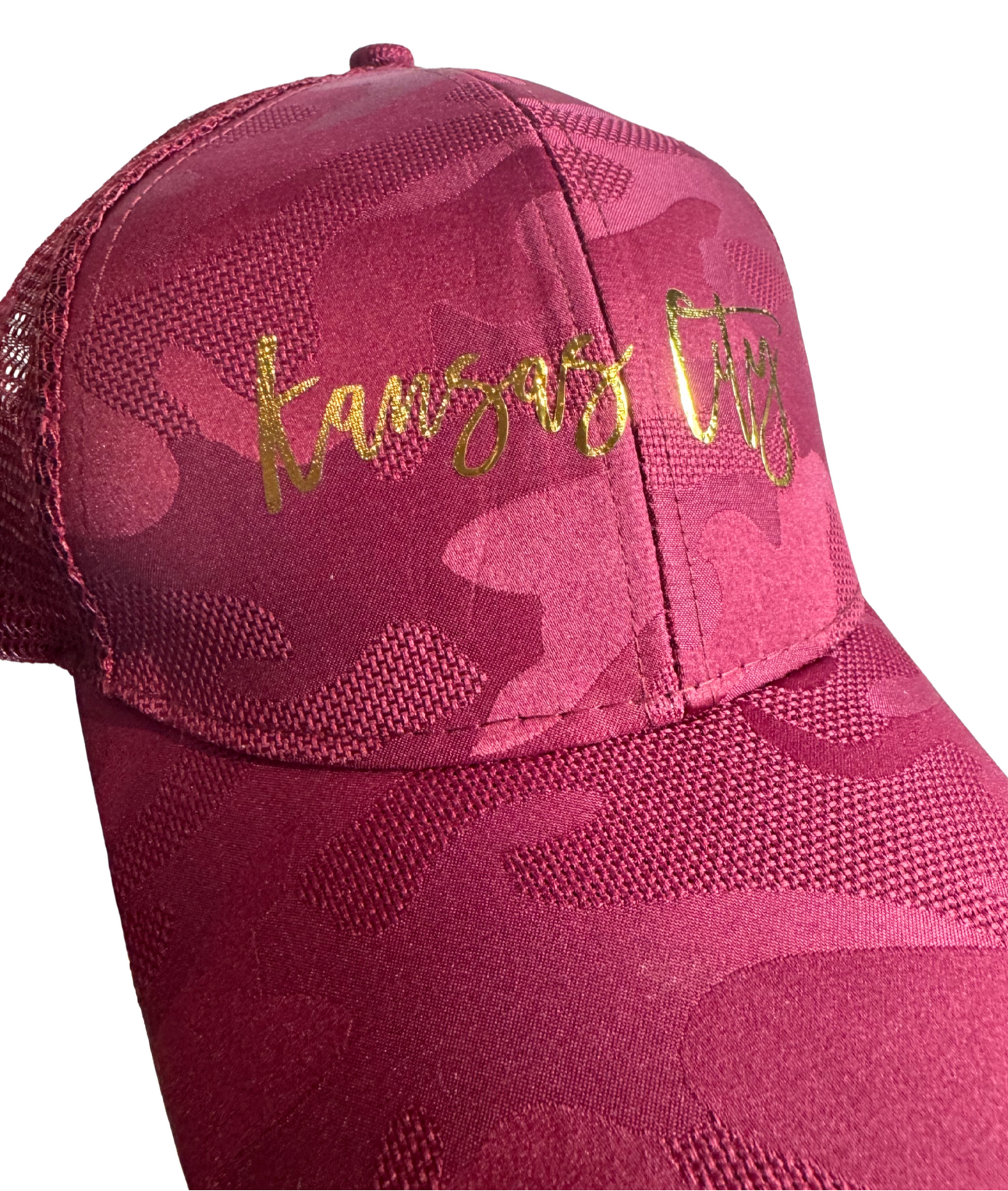 Wine camouflage cap with gold text on a white background