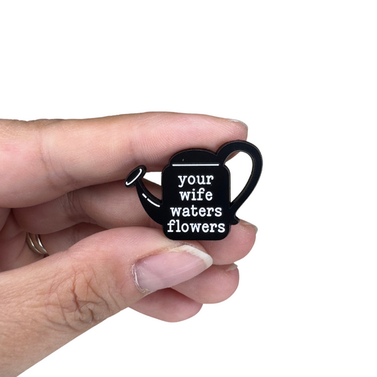 Hand holding the pin, showing its compact size and shiny finish.