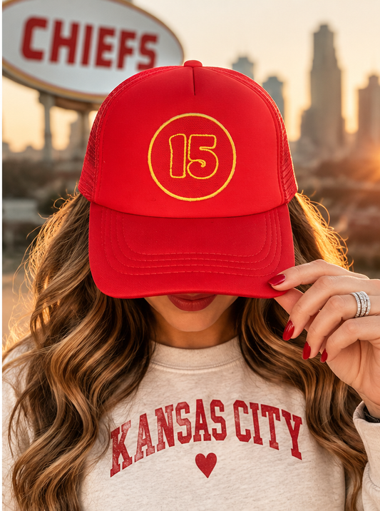 Model wearing 15 red Kansas City trucker hat