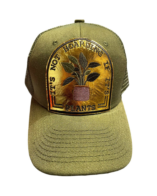 Army Green Trucker Hat with gold patch saying "It's Not Hoarding If It's Plants".
