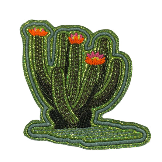 Handmade large leggy cactus with flowers iron-on patch featuring neon pink, neon yellow, and neon orange blooms with a green metallic vinyl base and aqua outline.