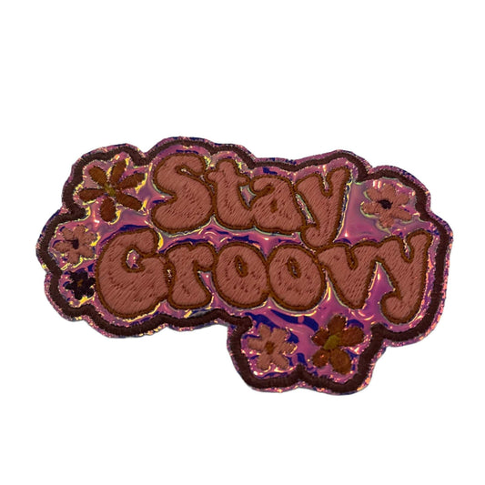 Holographic pink retro flower design iron-on patch with "Stay Groovy" lettering.