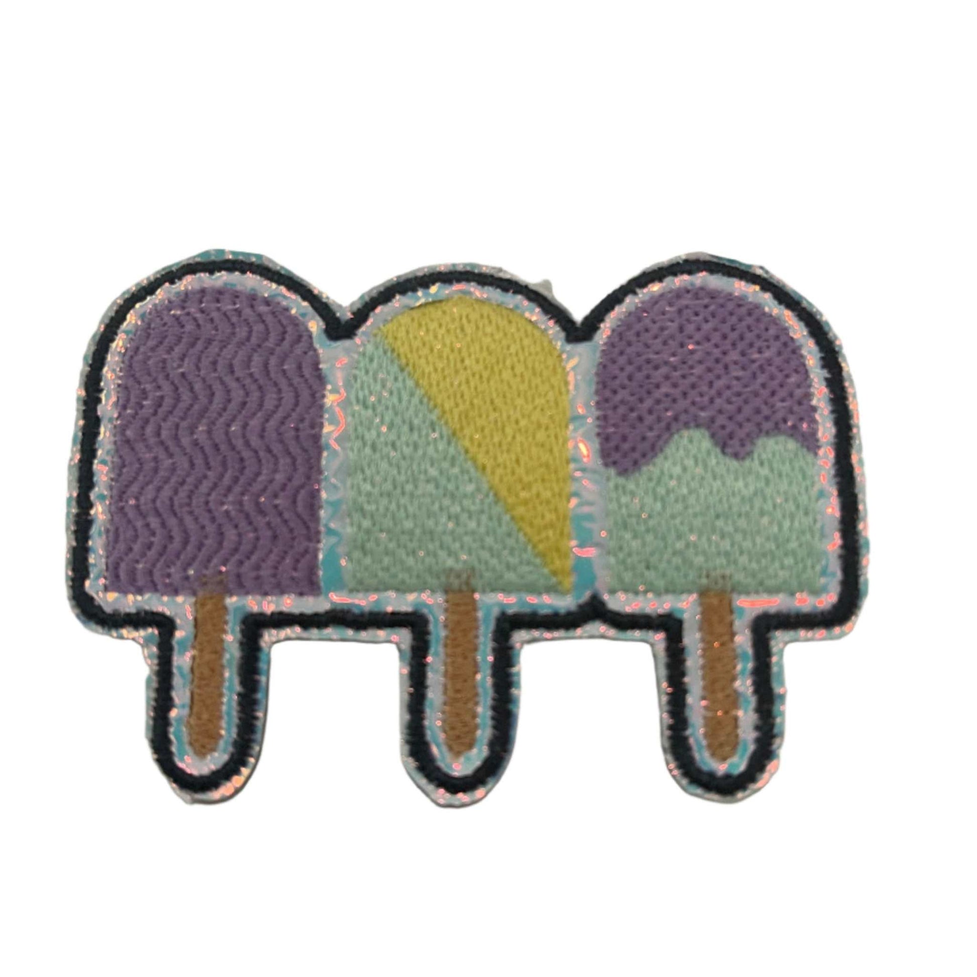 Handmade pastel popsicles iron-on patch in lavender, butter yellow, mint, light tan sticks, with holographic silver vinyl accents.