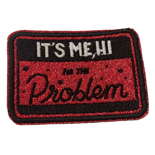 Iron-on patch with "It's Me, Hi" lyrics from Taylor Swift's "Anti-Hero" in red and black design.