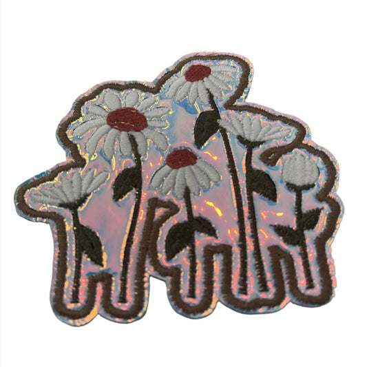 Handmade daisies iron-on patch with white petals, mauve centers, dark green stems, taupe outline, holographic vinyl background.