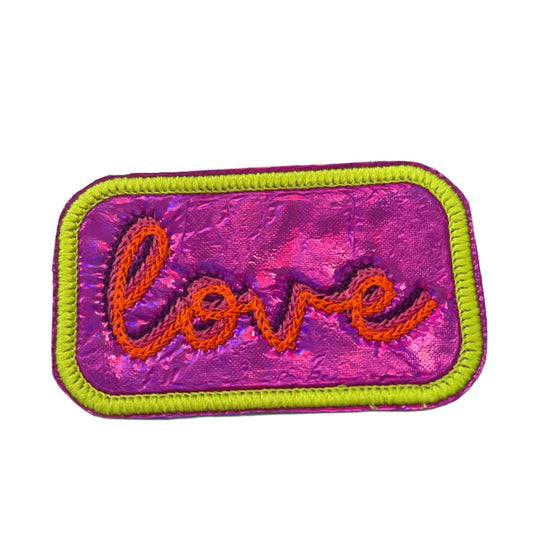 Neon "Love" iron-on patch with vibrant colors on a shiny retro background.